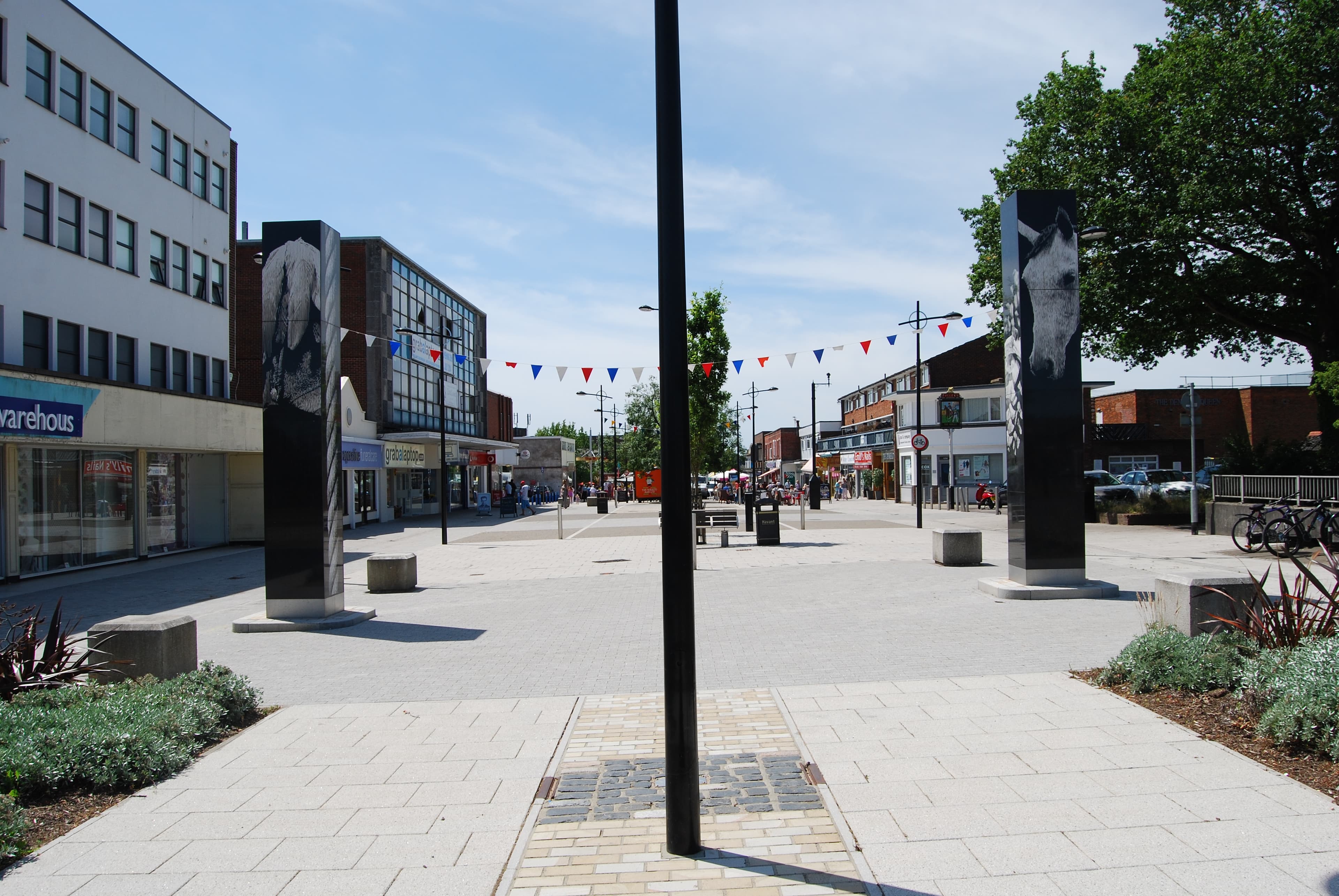 Waterlooville town centre — Queens Parade with street art murals, bunting and shops