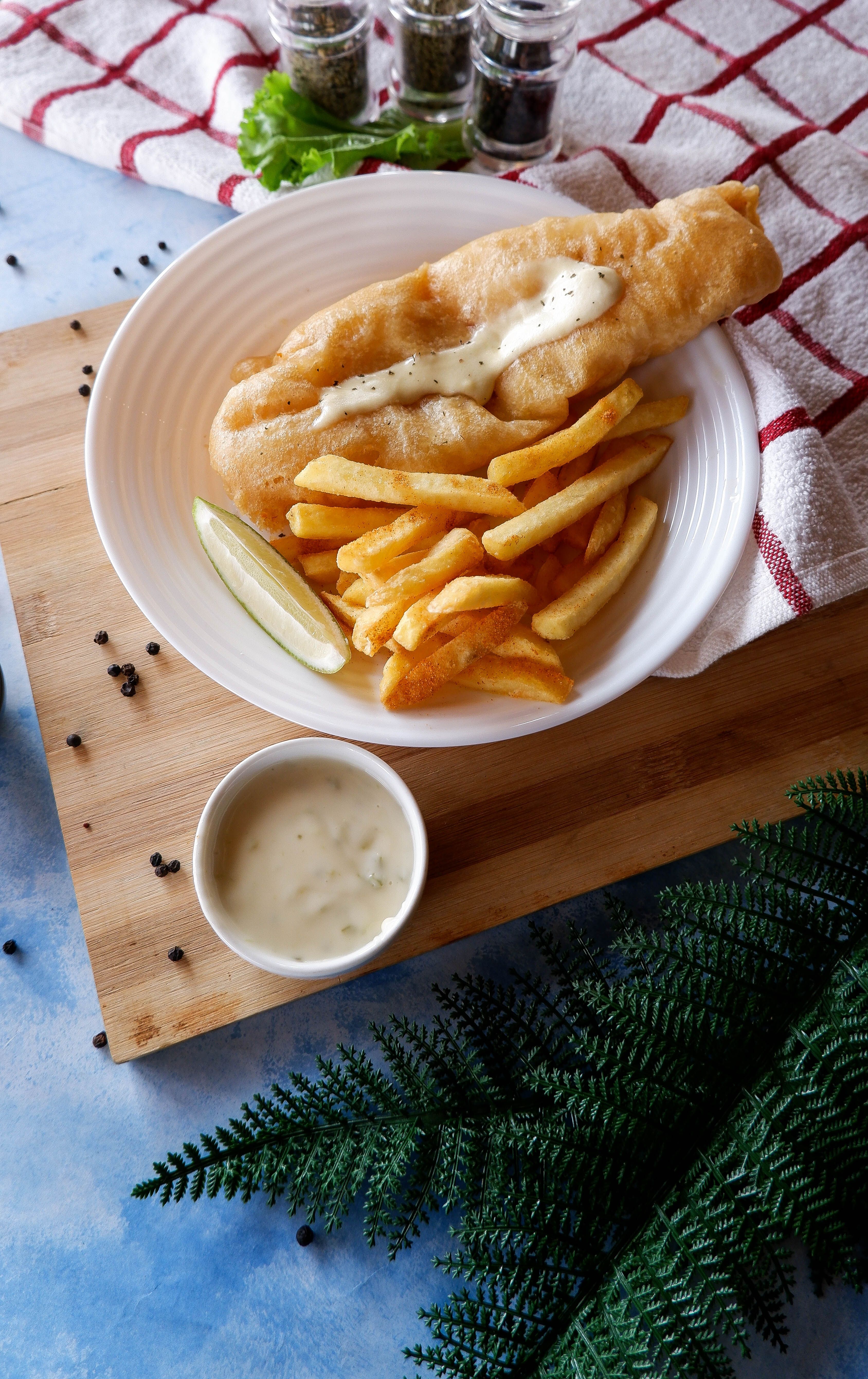 Fish and chips wrapped in paper, representative image